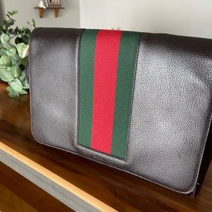 Gucci dark brown leather messenger bag with vintage stripes in used condition.